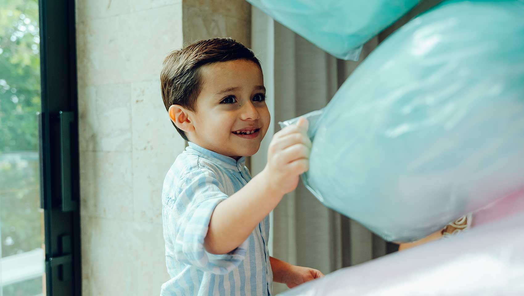 Seasonal Celebrationslittle boy with bags of cotton candy