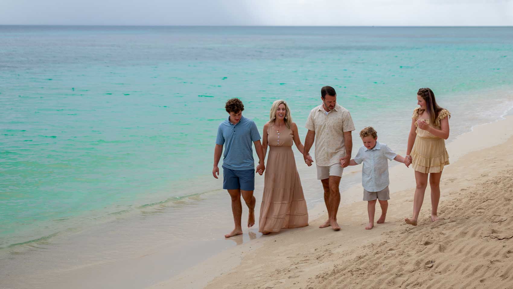 Family walking on Roatan beach