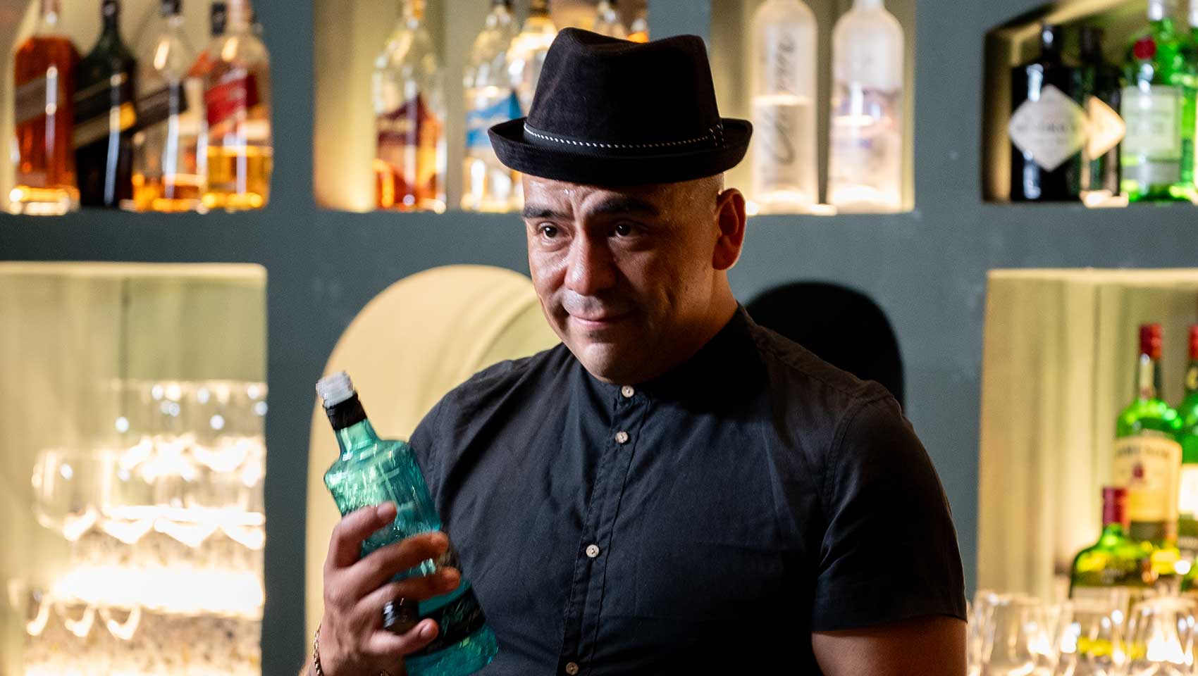 Bartender lines up cocktails at Kimpton Grand Roatan