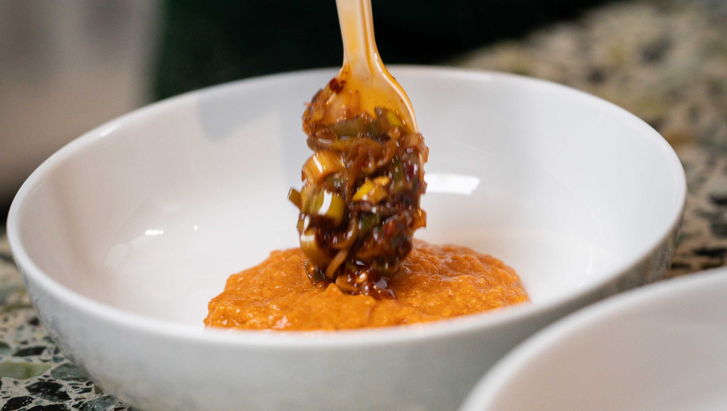 Chef garnishes dish at Kimpton Grand Roatan