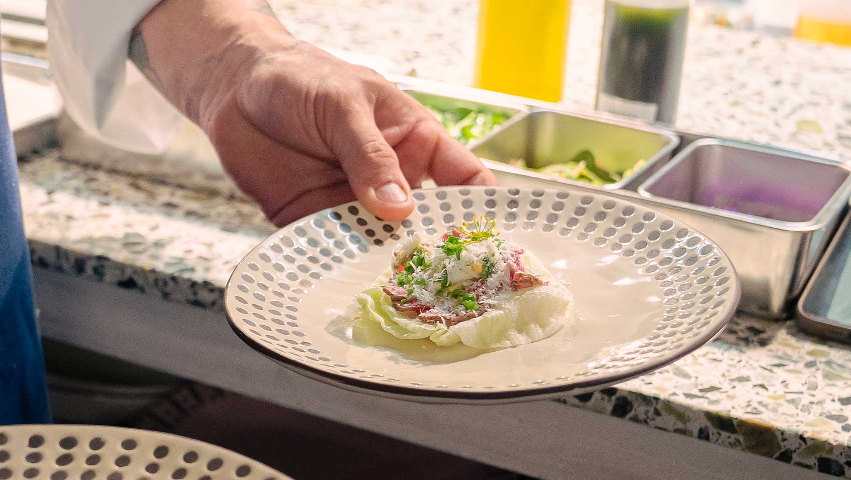 Guest Chef Pablo Diaz arranges a dish