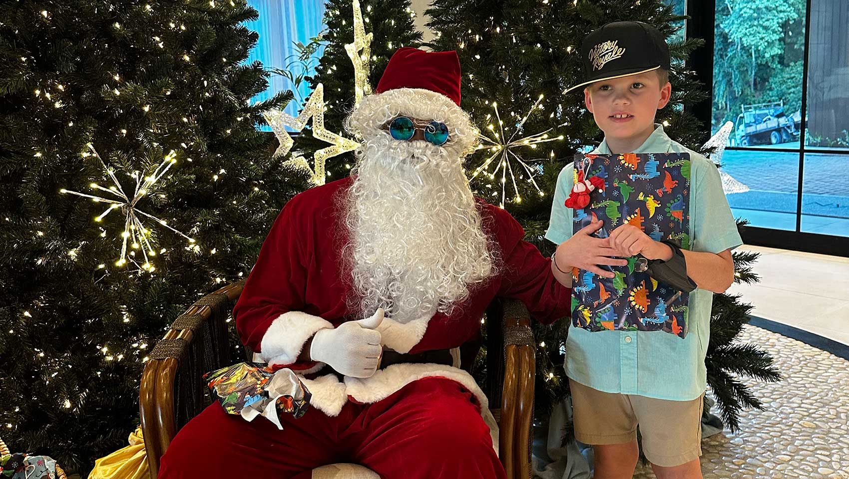 boy stand next to santa claus in grand Roatan lobby