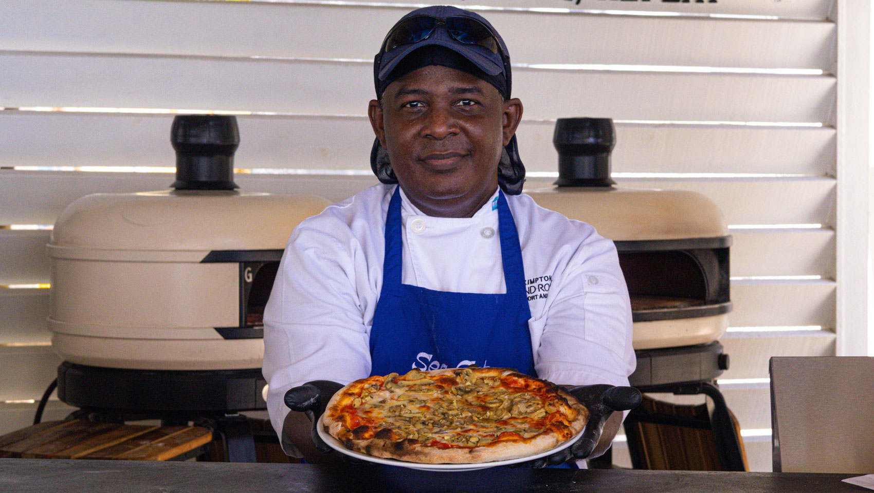 Sea cat employee holding pizza
