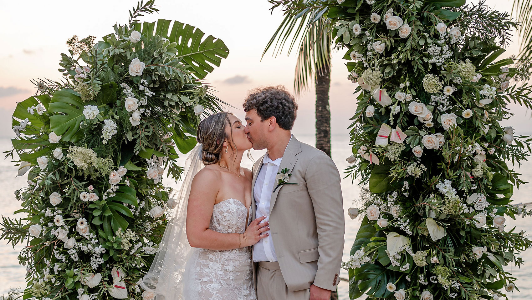 Couple in front of ceremony flowers