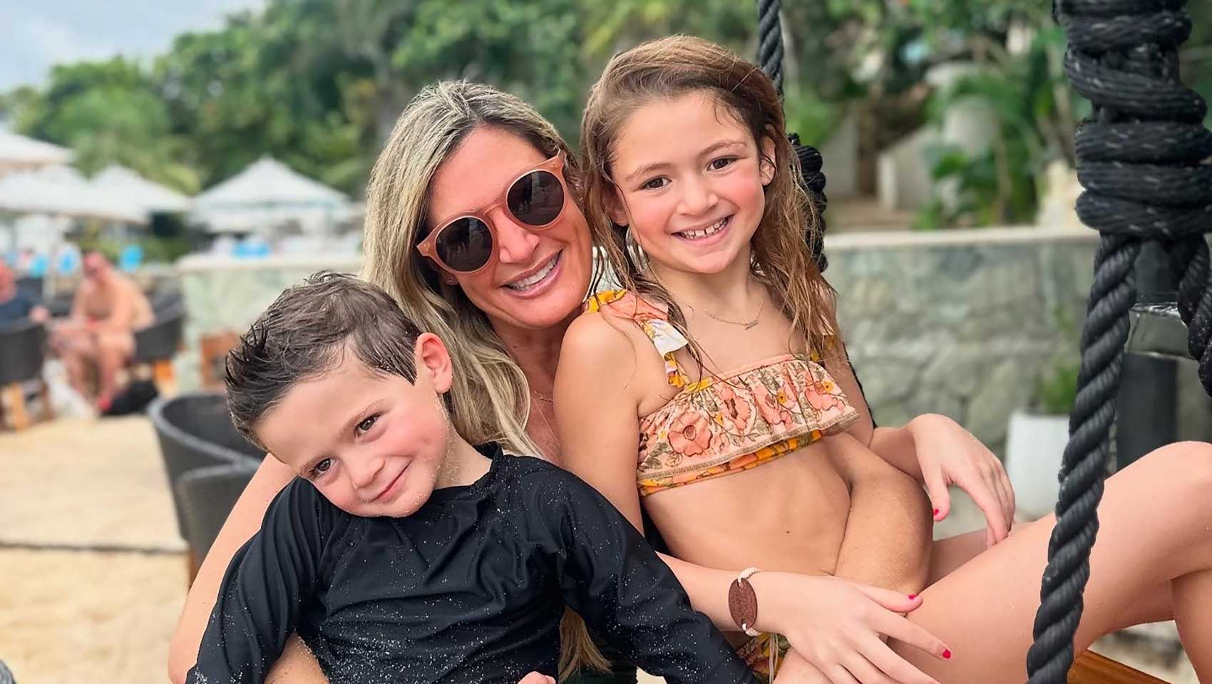mom on beach with son and daughter
