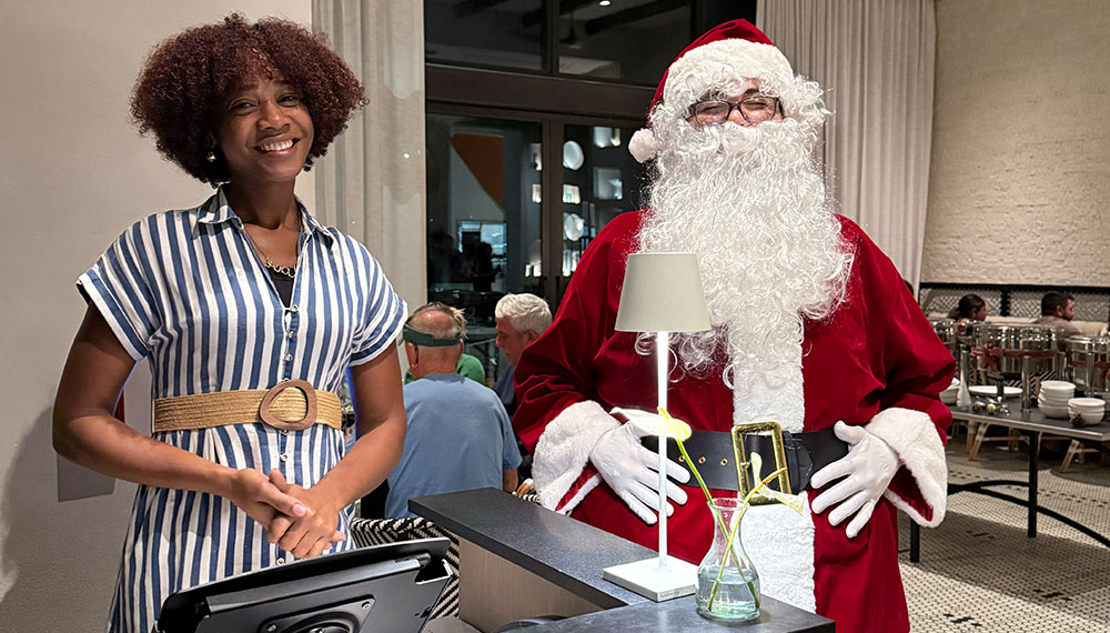 woman standing with Santa Claus at Alera entrance