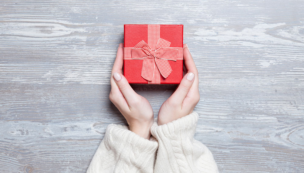 hands holding a small holiday giftbox