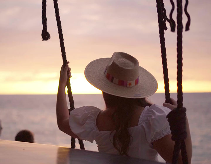 woman on outdoor swing overlooking ocean