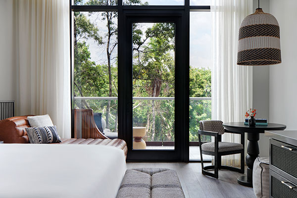 Sleeping area of 1 King Mobility Accessible Roll in Shower at Kimpton Grand Roatan Resort