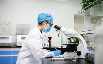 Doctor looking in microsope