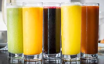 5 glasses of juice, all different colors