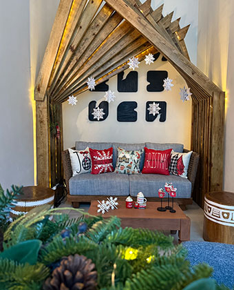 sofa decorated for the holidays with pillows, hanging snowflakes and Christmas décor at Kimpton grand roatan